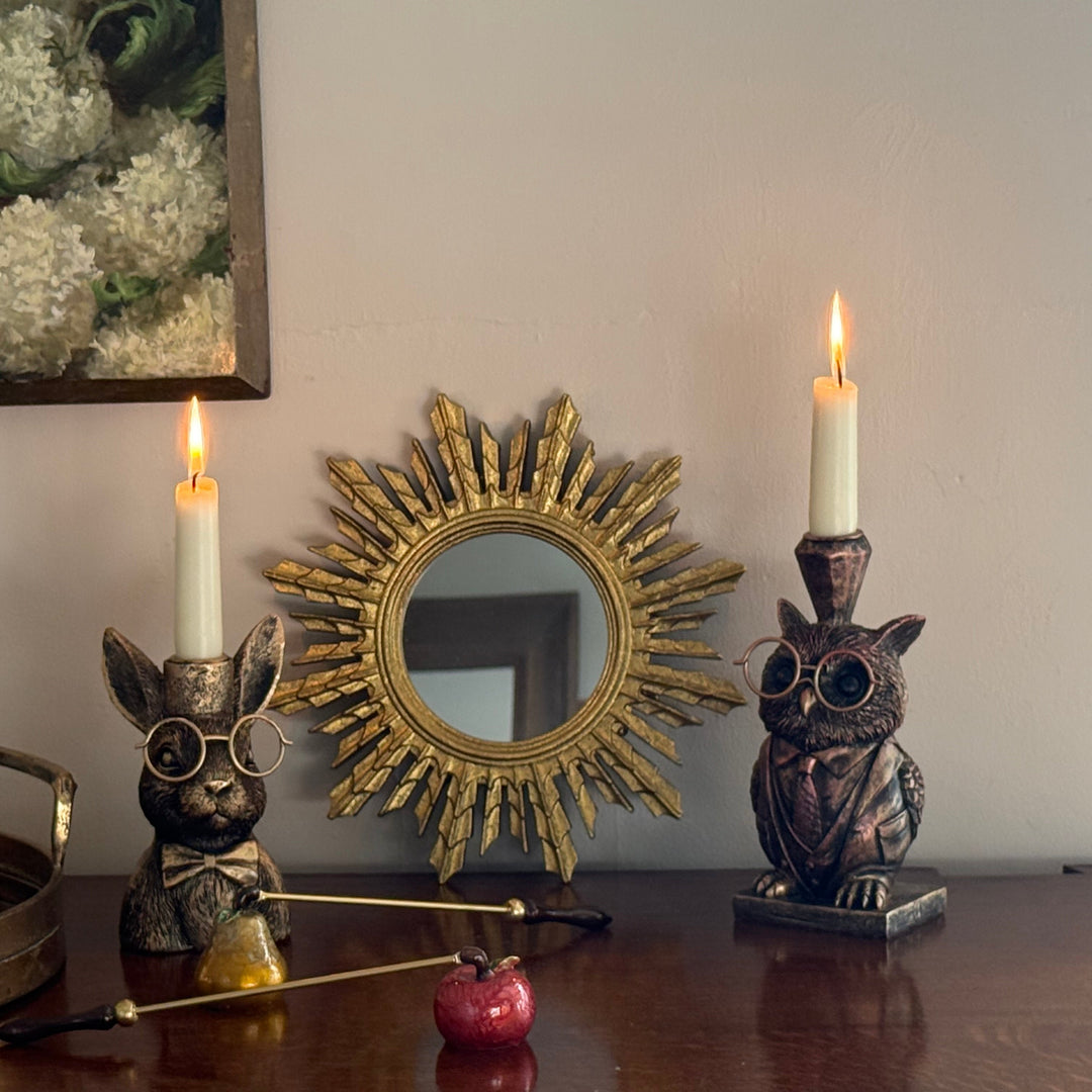 Decorative items including candles, a mirror, and statues on a table.