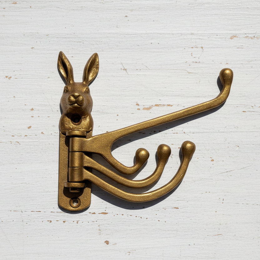 Gold rabbit-shaped wall hook on a white background
