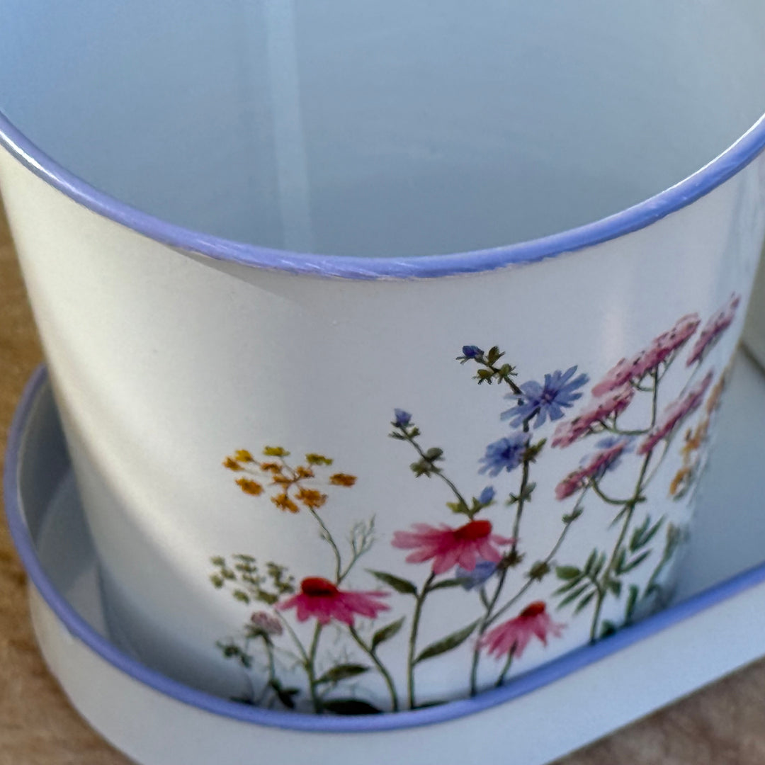 Ceramic pot with floral design on a wooden surface