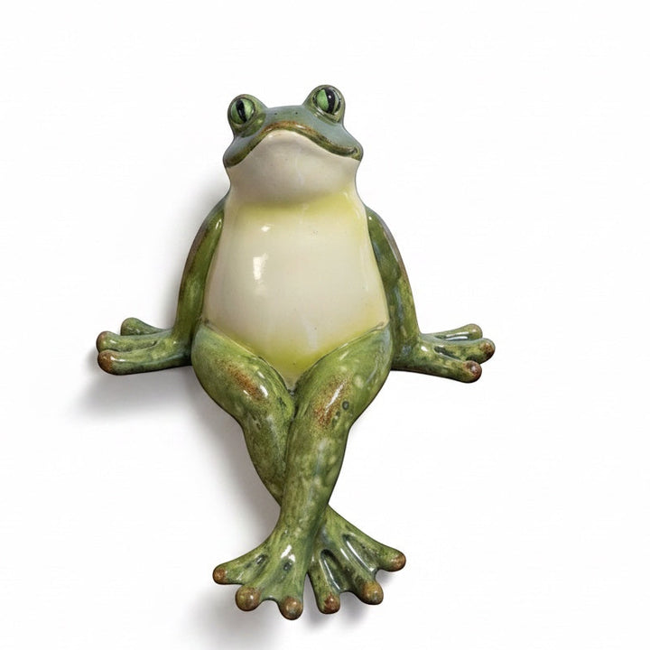 Resin frog shelf sitter with a glossy green finish and relaxed crossed-leg pose.