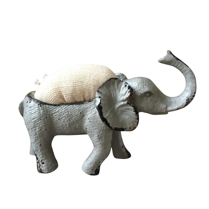 Shabby chic French grey metal elephant pin cushion with a hessian padded back and two sewing pins.
