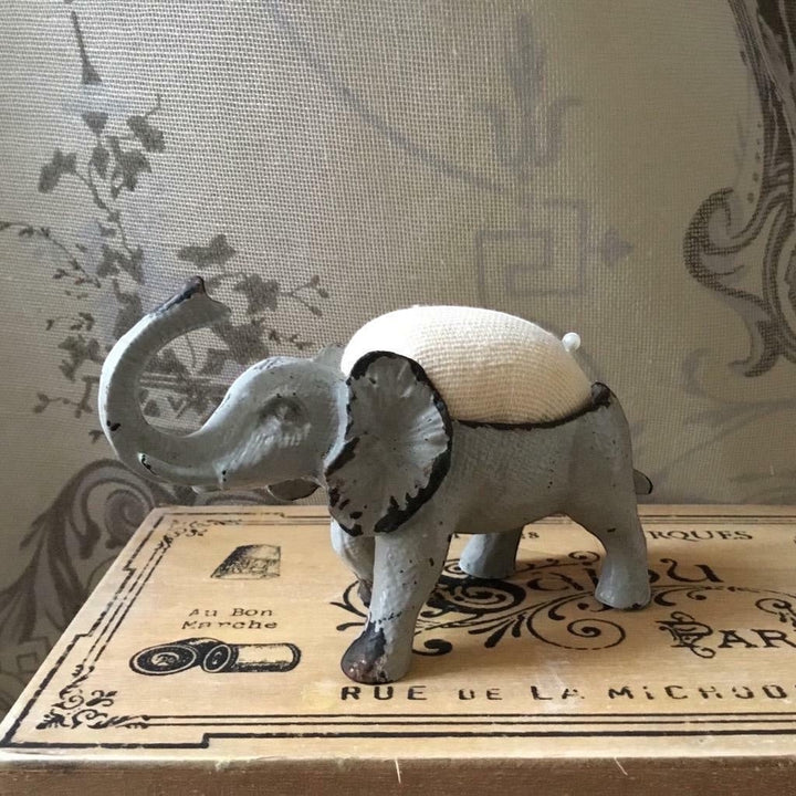 Shabby chic French grey metal elephant pin cushion with a hessian padded back and two pins.