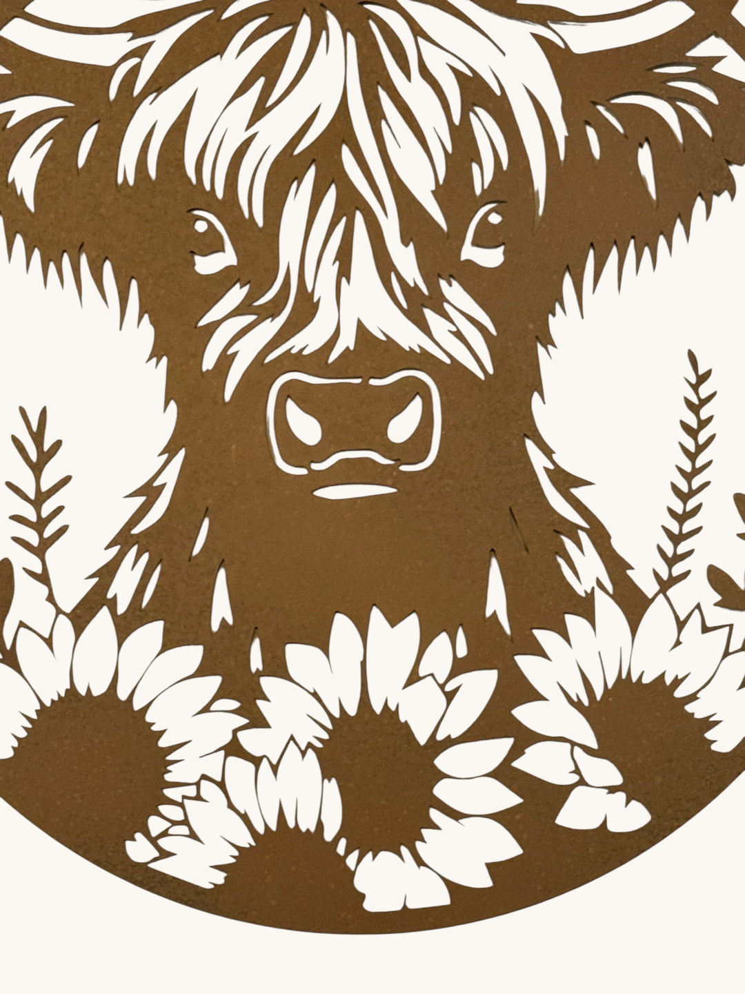 large rusty metal wall plaque featuring a detailed Highland cow surrounded by sunflowers and foliage.