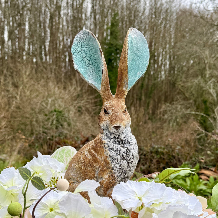 Vintage Hare rustic resin hare ornament with turquoise crackle ears, 41cm tall, surrounded by white flowers.